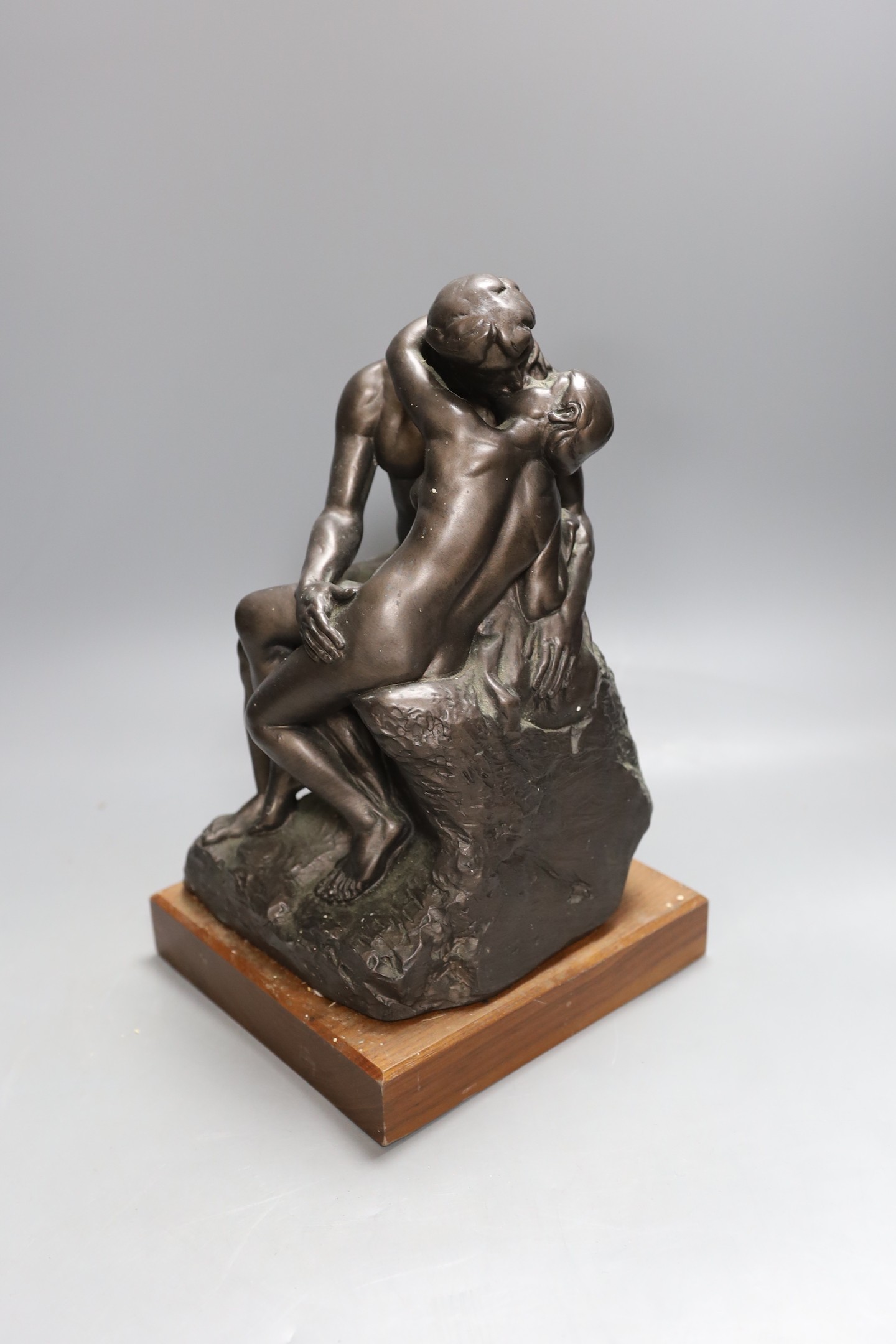 A simulated bronze figure group of seated embracing couple - 30cm tall